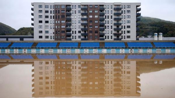 Apartment buildings reflected in a flooded football pitch in the village of Kiseljak, northern Bosnia. Pic: AP